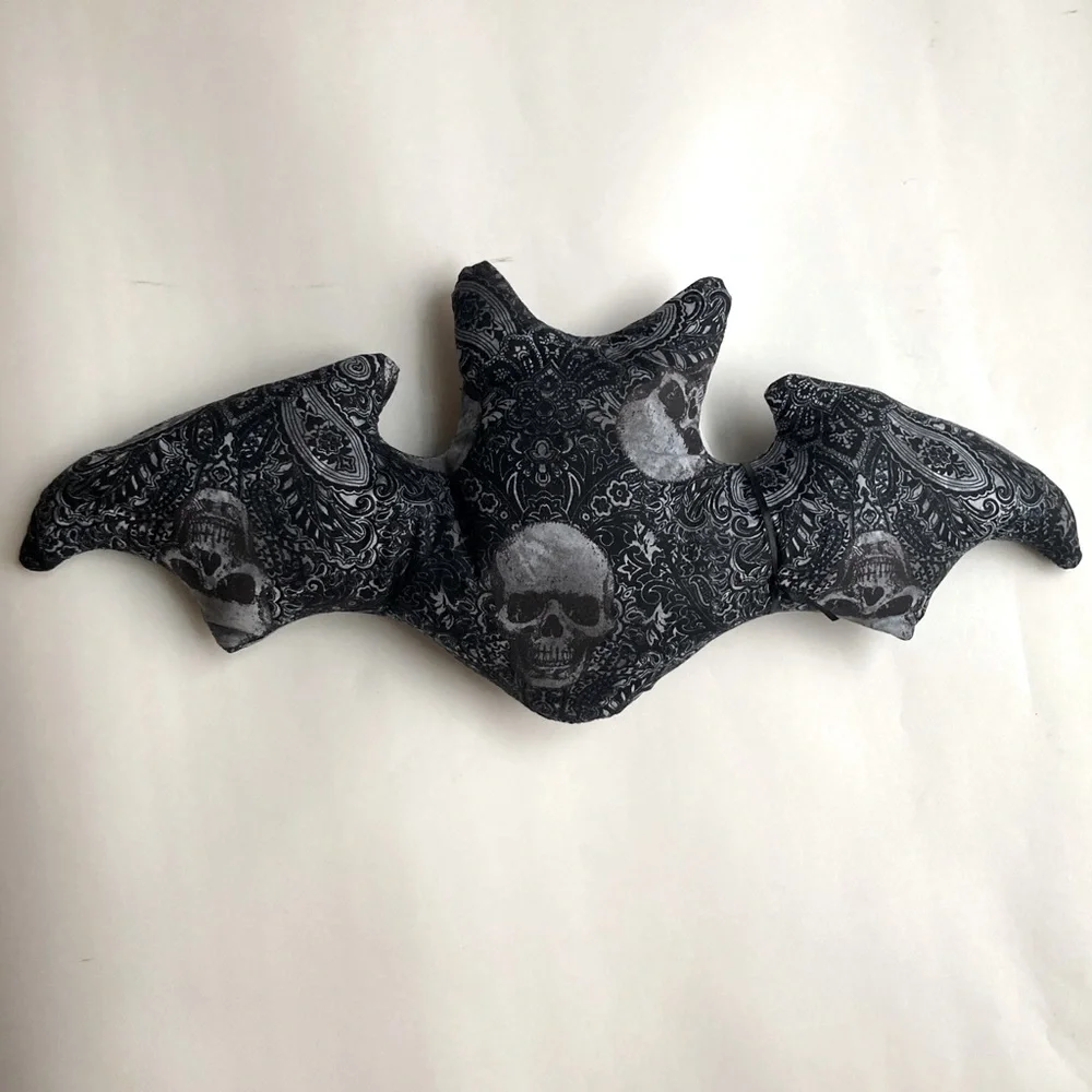 Grey skull and paisley bat shaped pillow
